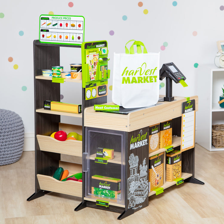 A playroom scene with The Melissa & Doug Harvest Market Grocery Store and Companion Collection Accessories