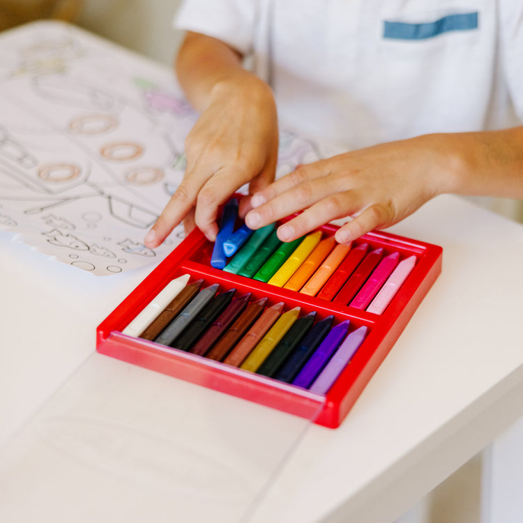 A kid playing with The Melissa & Doug Jumbo Coloring Pad: Vehicles - 50 Pages of White Bond Paper (11 x 14 inches)