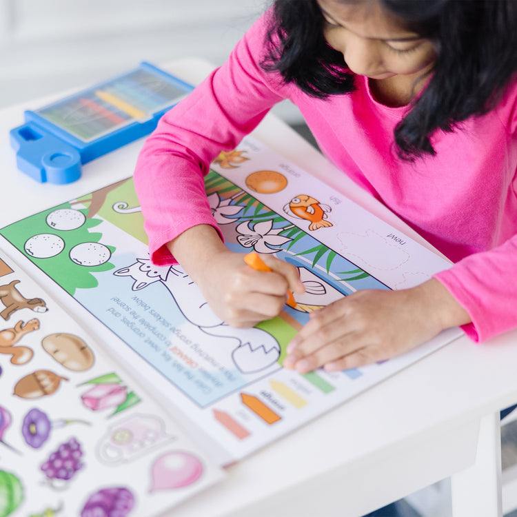 A kid playing with The Melissa & Doug Colors and Shapes Coloring and Sticker Activity Pad