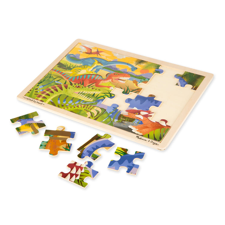 The loose pieces of The Melissa & Doug Dinosaurs Wooden Jigsaw Puzzle With Storage Tray (24 pcs)