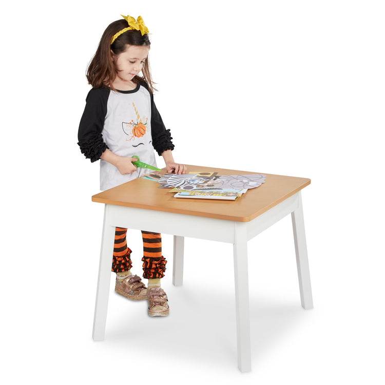 A child on white background with The Melissa & Doug Wooden Square Table – Kids Furniture for Playroom (Natural/White)