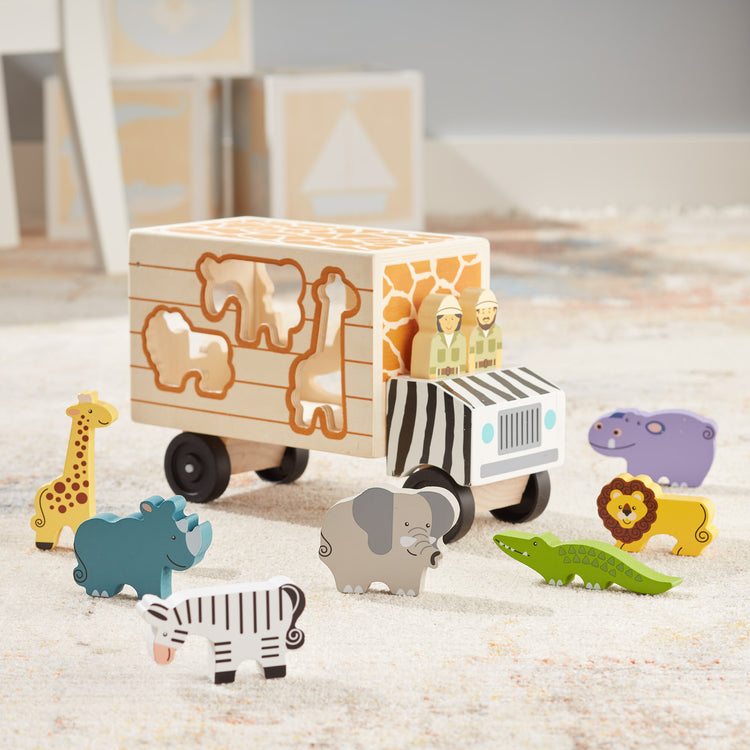 A playroom scene with The Melissa & Doug Animal Rescue Shape-Sorting Truck - Wooden Toy With 7 Animals and 2 Play Figures