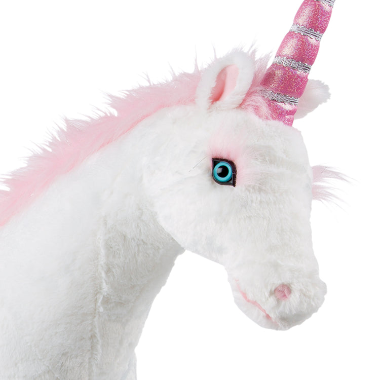 The loose pieces of The Melissa & Doug Giant Unicorn - Lifelike Plush Stuffed Animal (over 2 feet tall)