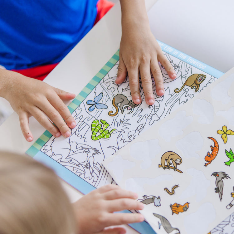 A kid playing with The Melissa & Doug Seek and Find Sticker Pad, Animals (400+ Stickers, 14 Scenes to Color)