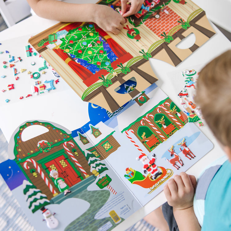 A kid playing with The Puffy Stickers Bundle - Santa's Workshop & 'Tis the Season