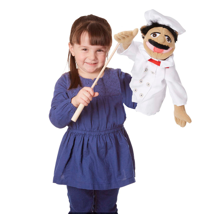 A child on white background with The Melissa & Doug Chef Puppet (Al Dente) with Detachable Wooden Rod