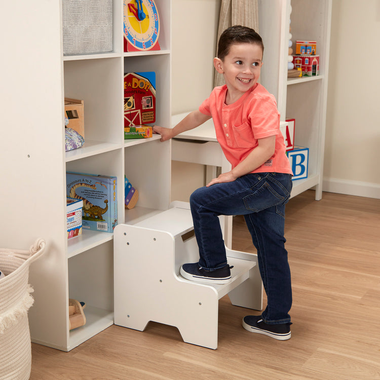 A kid playing with The Melissa & Doug Kids Wooden Step Stool - White