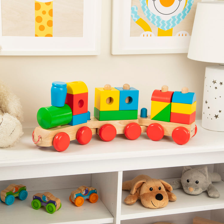 A playroom scene with The Melissa & Doug Wooden Jumbo Stacking Train – 4-Color Classic Wooden Toddler Toy (17 pcs)