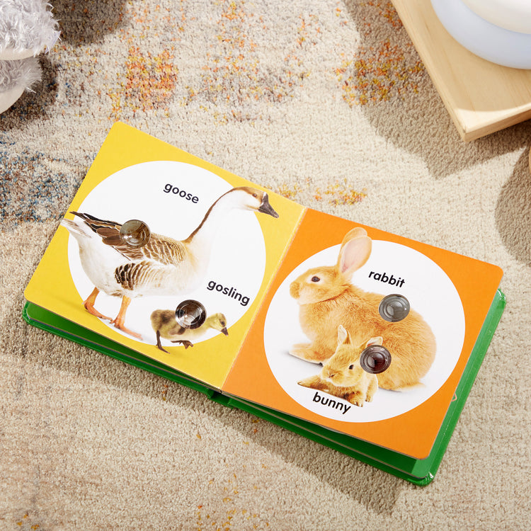 A playroom scene with The Melissa & Doug Children’s Book – Poke-a-Dot: Farm Animal Families (Board Book with Buttons to Pop)