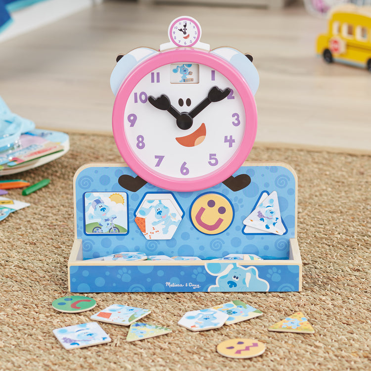 A playroom scene with The Melissa & Doug Blue's Clues & You! Wooden Tickety Tock Magnetic Clock (31 Pieces)