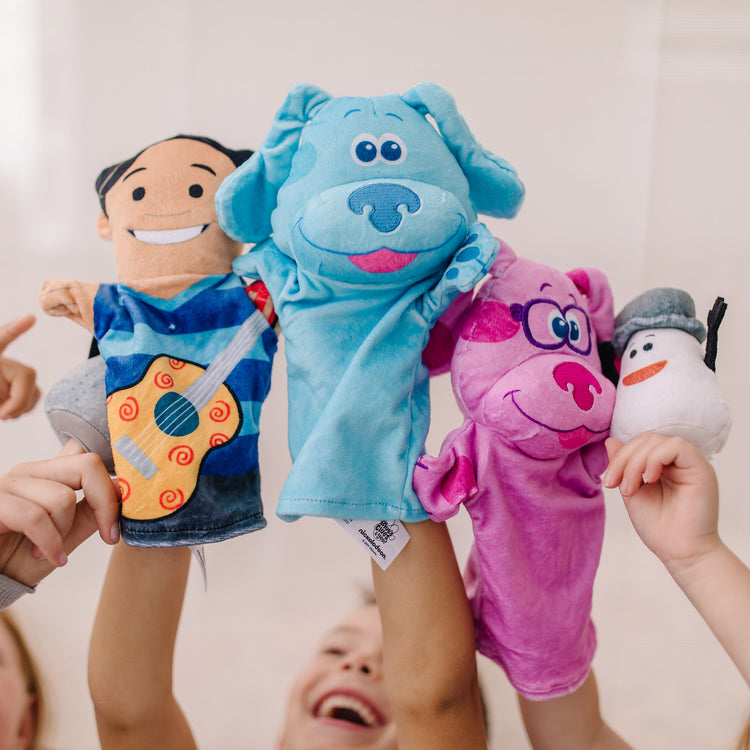 A kid playing with The Melissa & Doug Blue's Clues & You! Hand & Finger Puppets (5 Pieces)