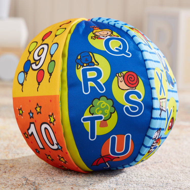 A playroom scene with The Melissa & Doug K's Kids 2-in-1 Talking Ball Educational Toy - ABCs and Counting 1-10