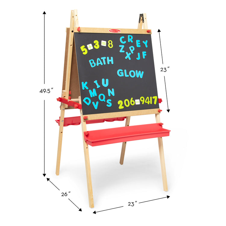 A kid playing with The Melissa & Doug Deluxe Magnetic Standing Art Easel With Chalkboard, Dry-Erase Board, and 39 Letter and Number Magnets