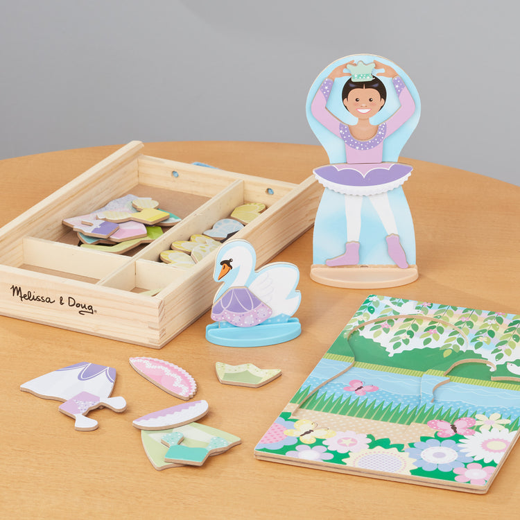 A playroom scene with The Melissa & Doug Ballerina And Fairy Magnetic Dress-Up Double-Sided Wooden Doll And Swan Pretend Play Set (52 pcs)