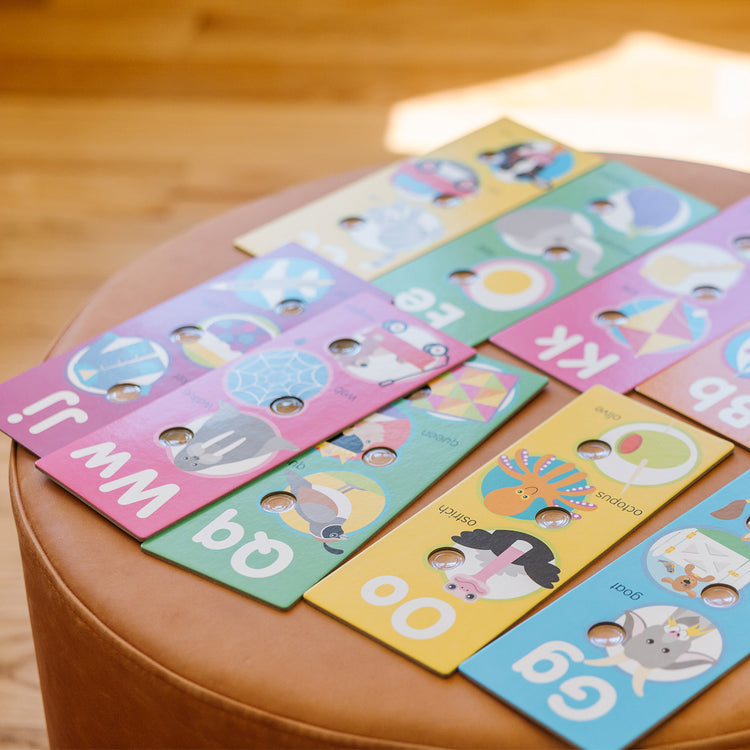 A kid playing with The Melissa & Doug Poke-a-Dot Alphabet Learning Cards