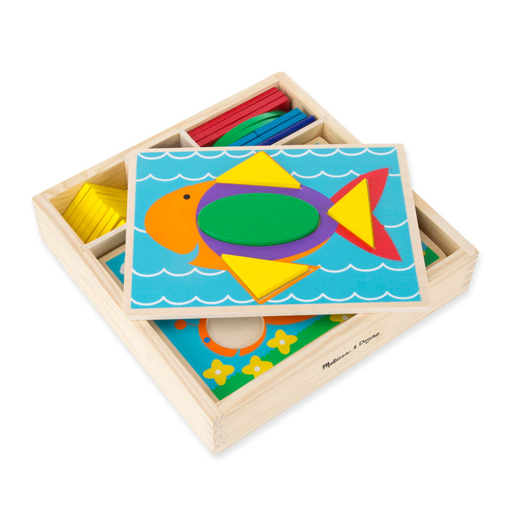 The loose pieces of The Melissa & Doug Beginner Wooden Pattern Blocks Educational Toy With 5 Double-Sided Scenes and 30 Shapes