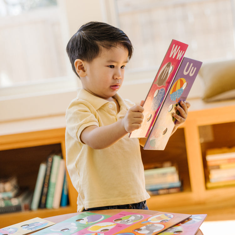 A kid playing with The Melissa & Doug Poke-a-Dot Alphabet Learning Cards