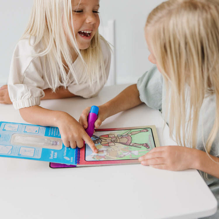 A kid playing with The Melissa & Doug On the Go Water Wow! Water Reveal Pad: Bible Stories