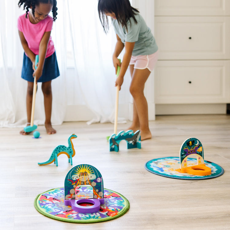 A kid playing with The Melissa & Doug Fun at the Fair! Mini Golf Play Set – 3 Multi-Themed Holes and Wooden Obstacles