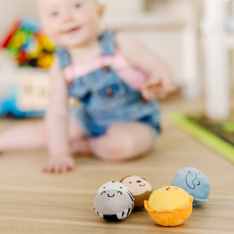 A kid playing with The Melissa & Doug Rollables Safari Friends Infant and Toddler Toy (4 Pieces)