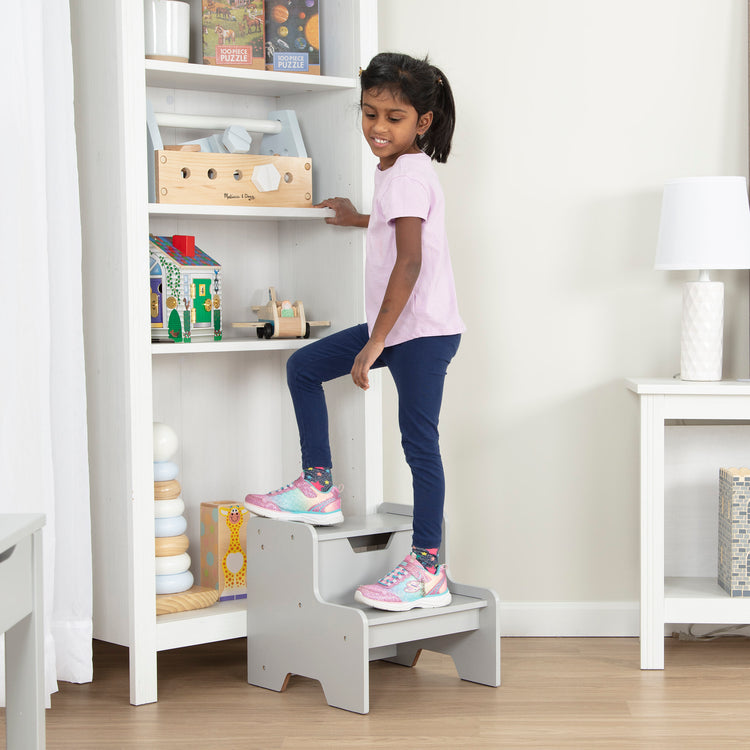 A kid playing with The Melissa & Doug Kids Furniture Wooden Step Stool - Gray