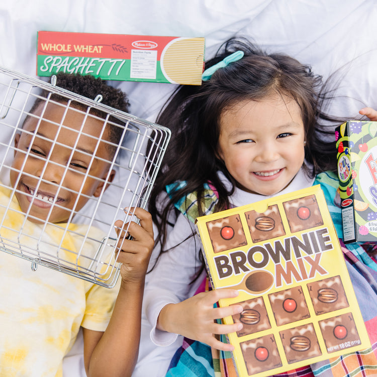 A kid playing with The Melissa & Doug Grocery Basket - Pretend Play Toy With Heavy Gauge Steel Construction