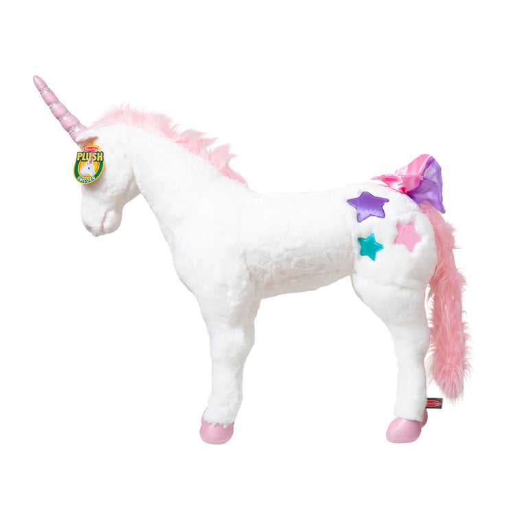 The front of the box for The Melissa & Doug Giant Unicorn - Lifelike Plush Stuffed Animal (over 2 feet tall)