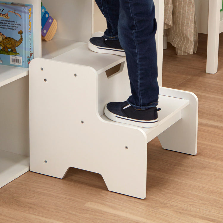 A kid playing with The Melissa & Doug Kids Wooden Step Stool - White