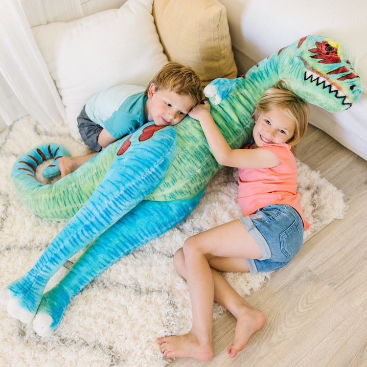 A kid playing with The Melissa & Doug Standing T-Rex Giant Lifelike Plush Stuffed Animal