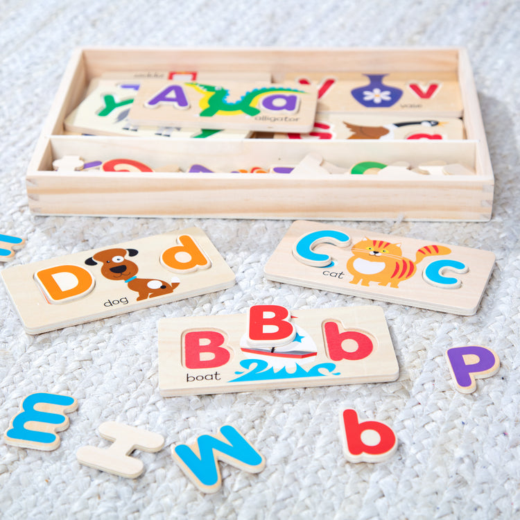 A playroom scene with The Melissa & Doug ABC Picture Boards - Educational Toy With 13 Double-Sided Wooden Boards and 52 Letters