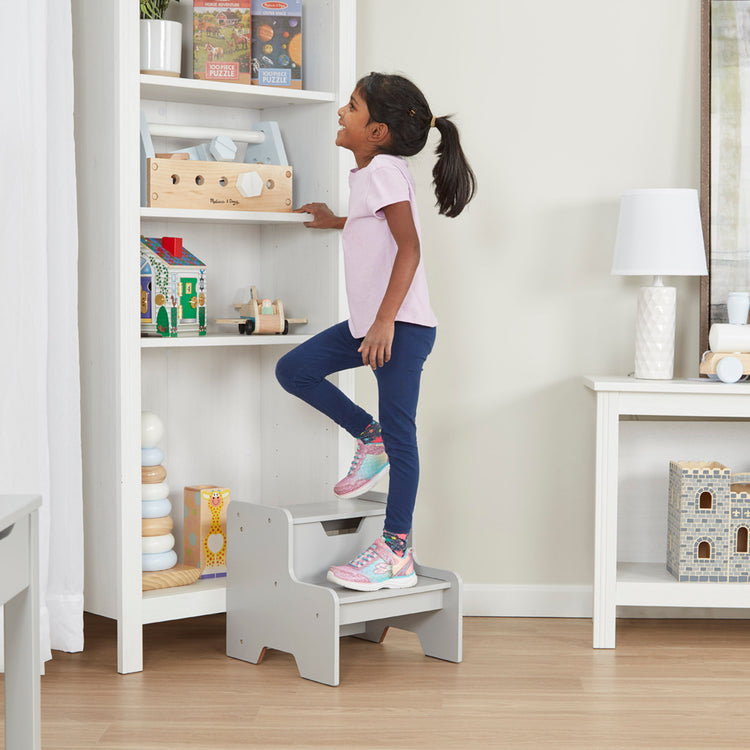 A kid playing with The Melissa & Doug Kids Furniture Wooden Step Stool - Gray