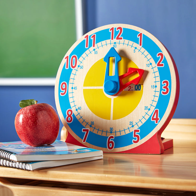 A kid playing with The Melissa & Doug Turn & Tell Wooden Clock - Educational Toy With 12+ Reversible Time Cards