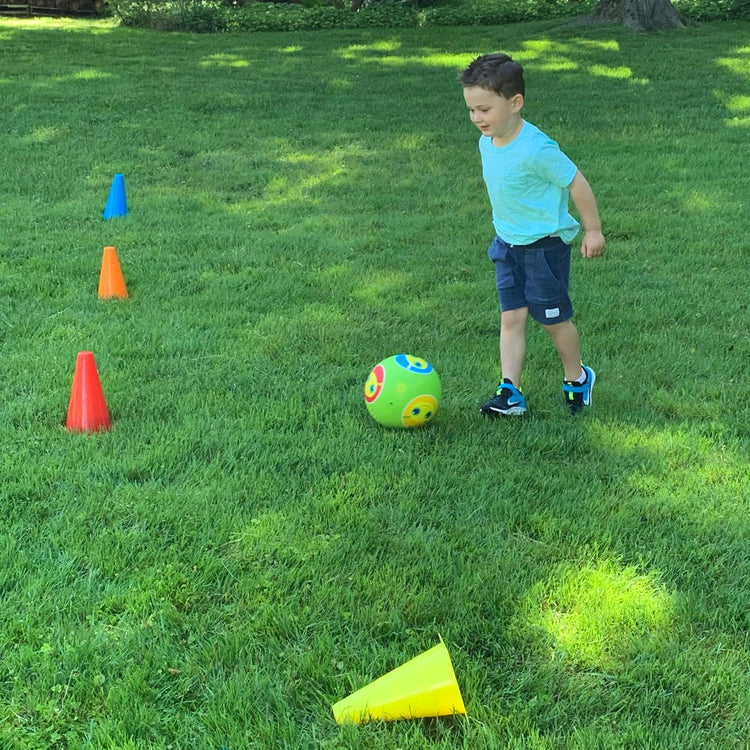 A kid playing with the Melissa & Doug 8 Activity Cones - Set of 8