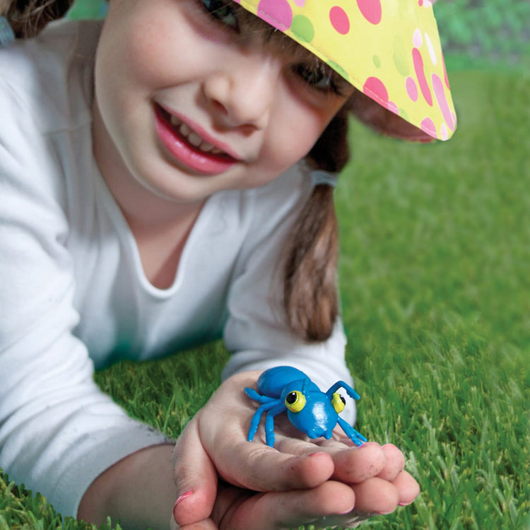 A kid playing with the Melissa & Doug Sunny Patch Bag of Bugs (10 pcs)