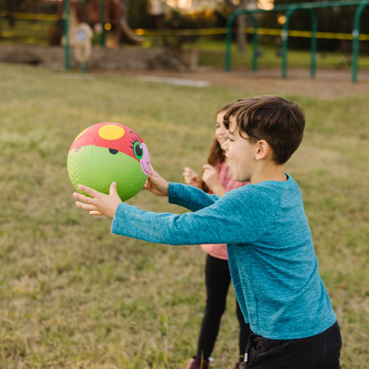 A kid playing with the Melissa & Doug Sunny Patch Bollie Ladybug Classic Rubber Kickball