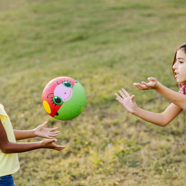 A kid playing with the Melissa & Doug Sunny Patch Bollie Ladybug Classic Rubber Kickball