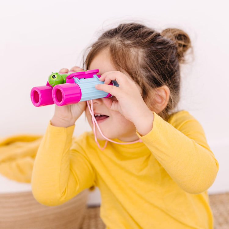 A kid playing with the Melissa & Doug Sunny Patch Cutie Pie Butterfly Binoculars - Pretend Play Toy