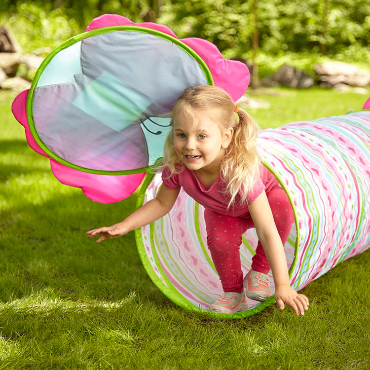 A kid playing with the Melissa & Doug Sunny Patch Cutie Pie Butterfly Crawl-Through Tunnel (almost 5 feet long)