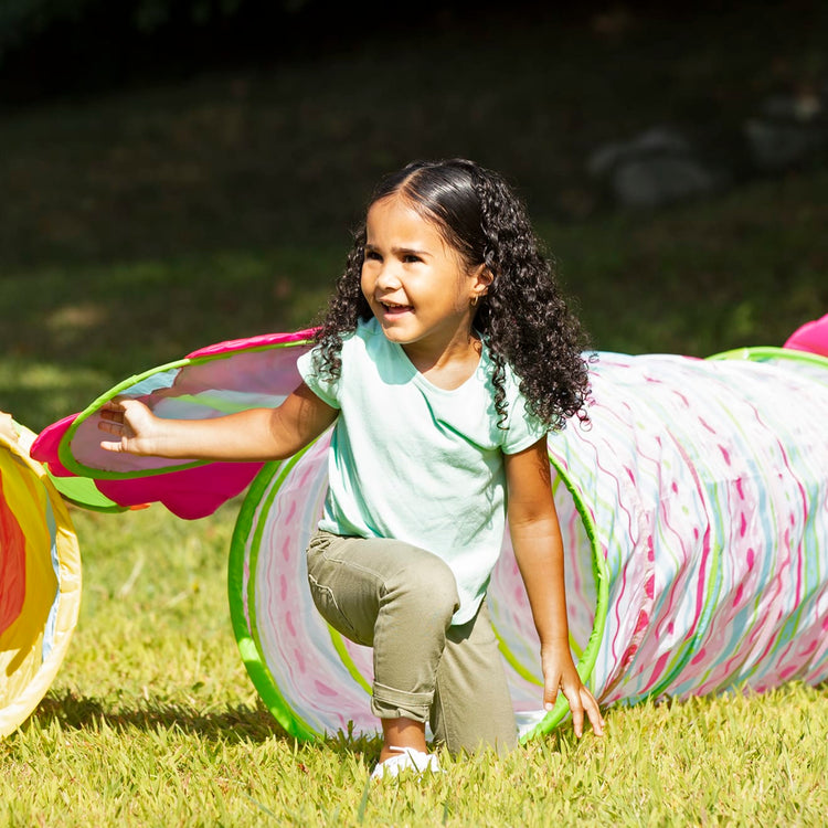 A kid playing with the Melissa & Doug Sunny Patch Cutie Pie Butterfly Crawl-Through Tunnel (almost 5 feet long)