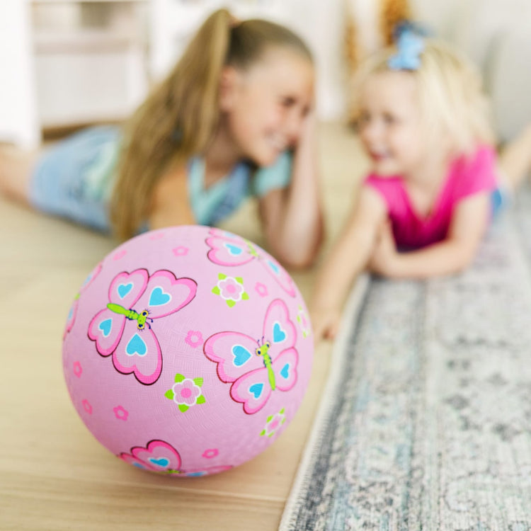 A kid playing with the Melissa & Doug Sunny Patch Cutie Pie Butterfly Classic Rubber Kickball