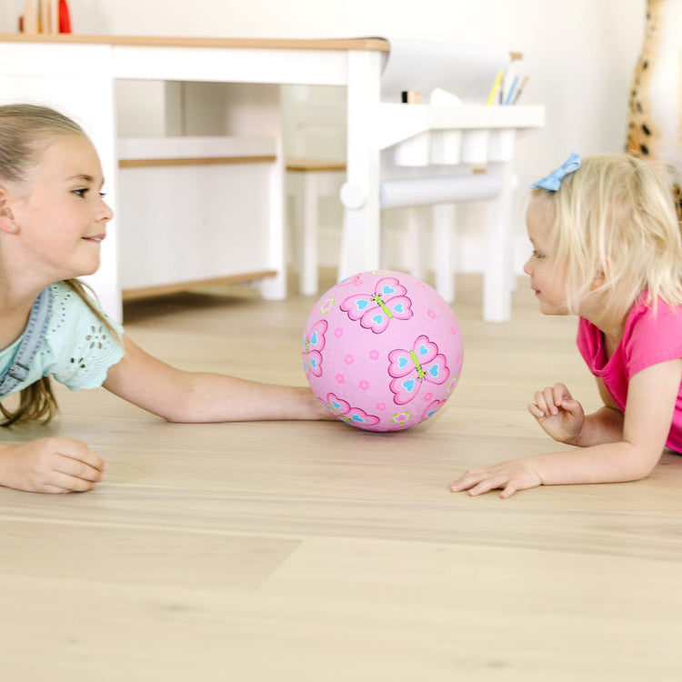 A kid playing with the Melissa & Doug Sunny Patch Cutie Pie Butterfly Classic Rubber Kickball