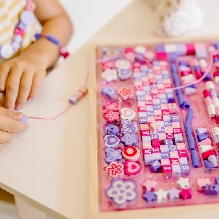 The front of the box for the Melissa & Doug Sparkle & Shimmer Wooden Bead Set: 340 Beads and 12 Laces for Jewelry-Making