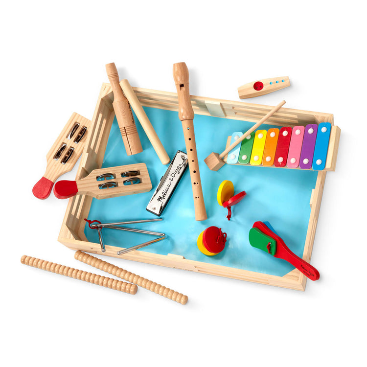 The loose pieces of the Melissa & Doug Deluxe Band Set With Wooden Musical Instruments and Storage Case