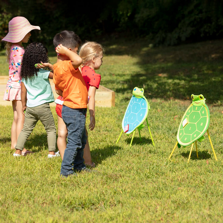 A kid playing with the Melissa & Doug Sunny Patch Dilly Dally Turtle Target Action Game