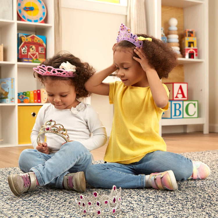 A kid playing with the Melissa & Doug Dress-Up Tiaras for Costume Role Play (4 pcs)