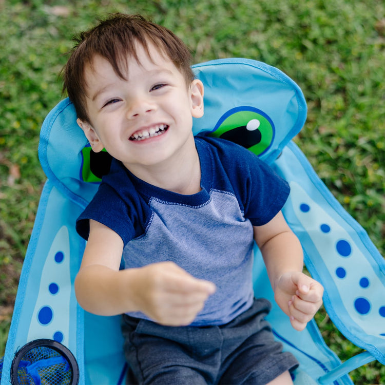 A kid playing with the Melissa & Doug Sunny Patch Flex Octopus Folding Beach Chair for Kids