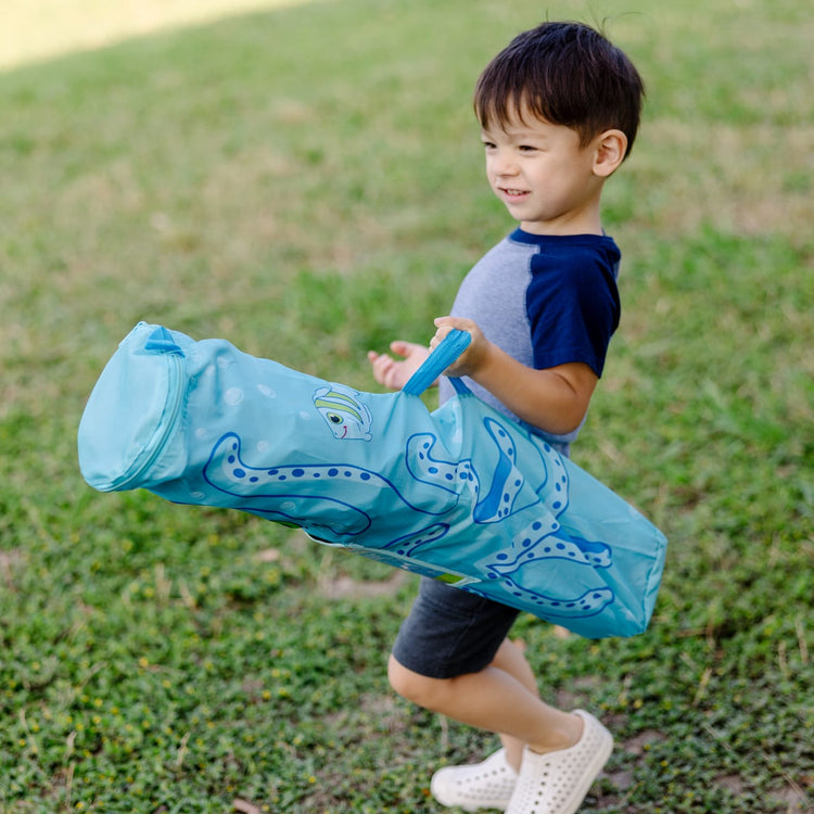 A kid playing with the Melissa & Doug Sunny Patch Flex Octopus Folding Beach Chair for Kids