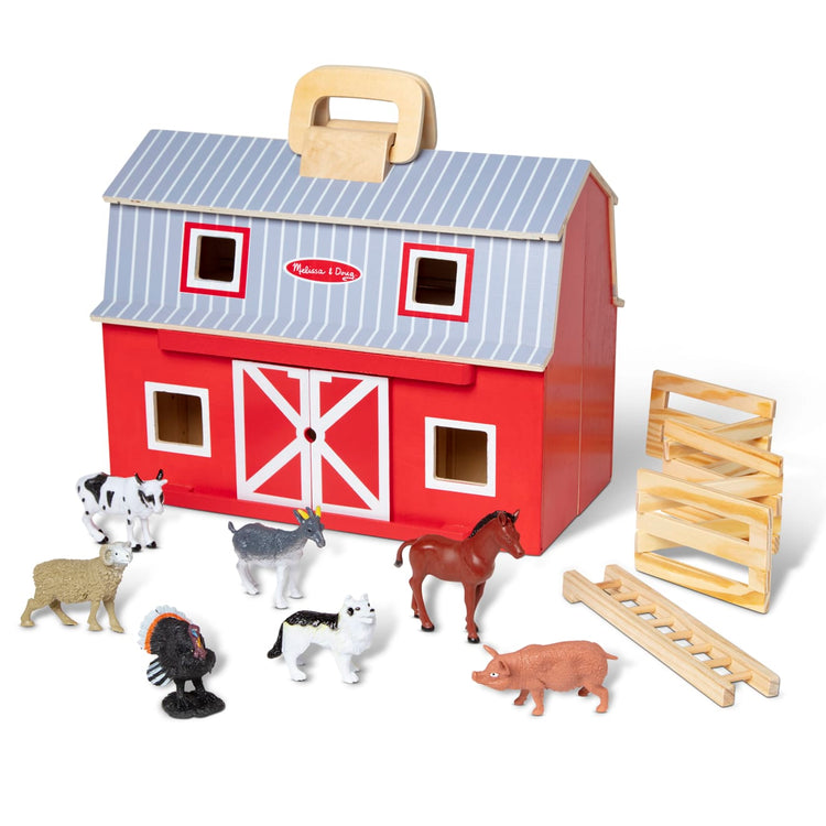 The loose pieces of the Melissa & Doug Fold and Go Wooden Barn With 7 Animal Play Figures