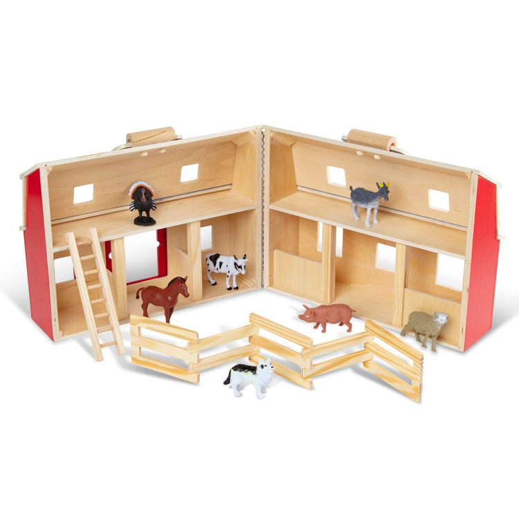 The loose pieces of the Melissa & Doug Fold and Go Wooden Barn With 7 Animal Play Figures