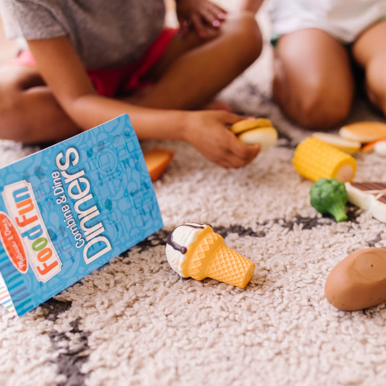 A kid playing with the Food Fun Combine & Dine Dinners - Blue